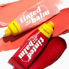 Tinted pink and berry colored lip balm