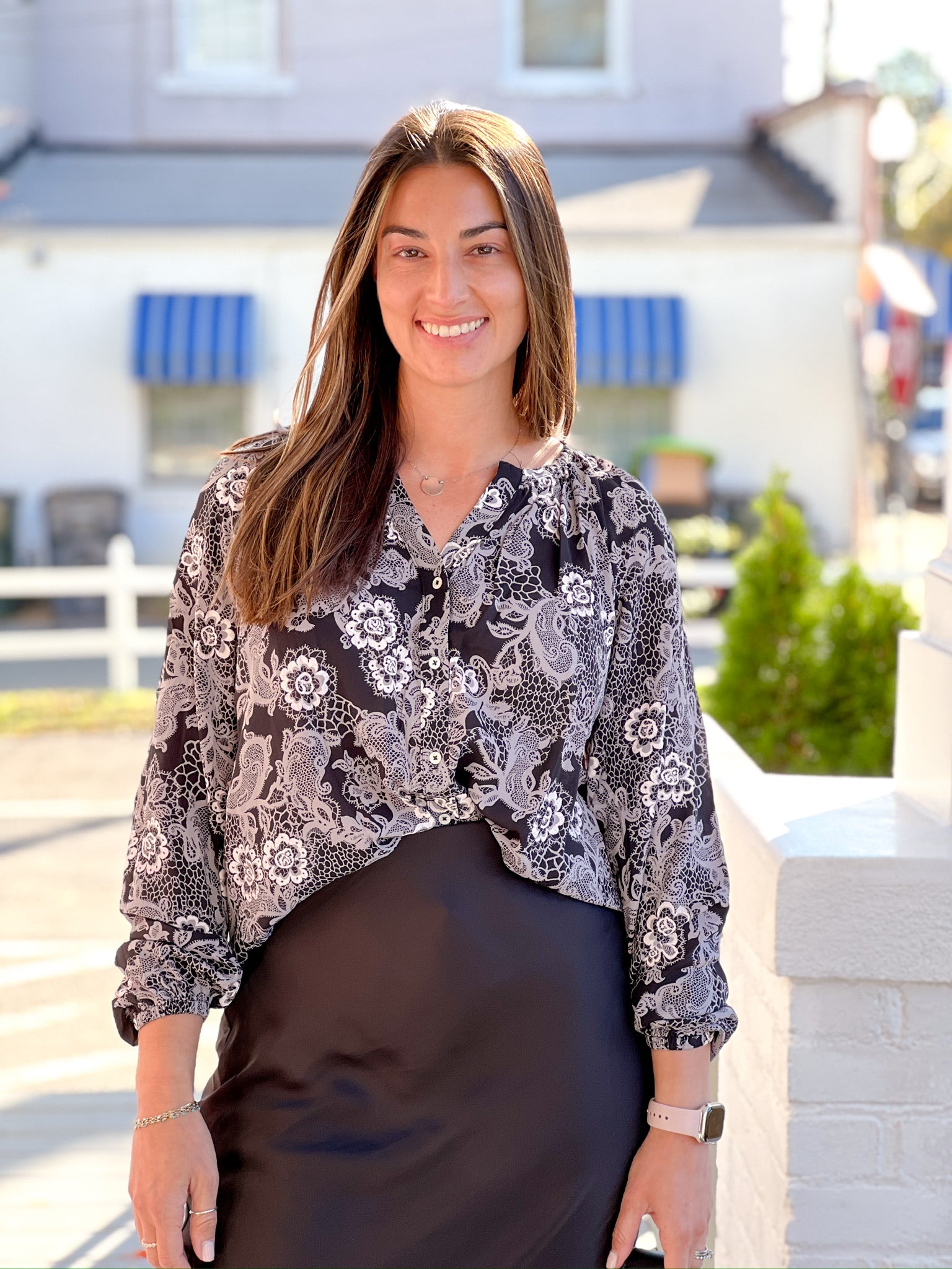 Black long sleeve work top with white/cream lacy floral print 