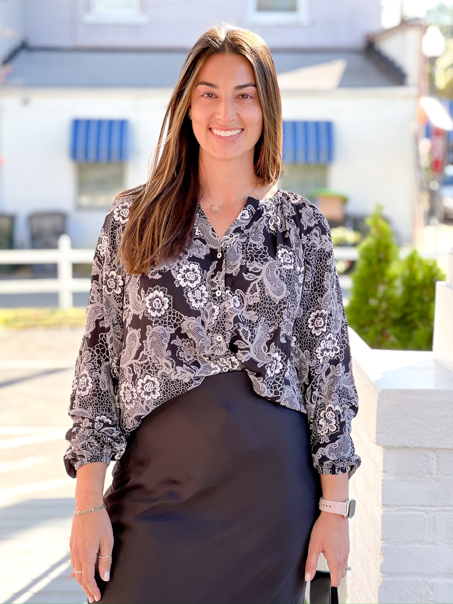 Black long sleeve work top with white/cream lacy floral print 