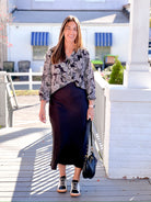 Black long sleeve work top with white/cream lacy floral print 