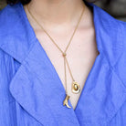 Gold plated necklace featuring a cowboy hat and cowboy pendant on a lariat.