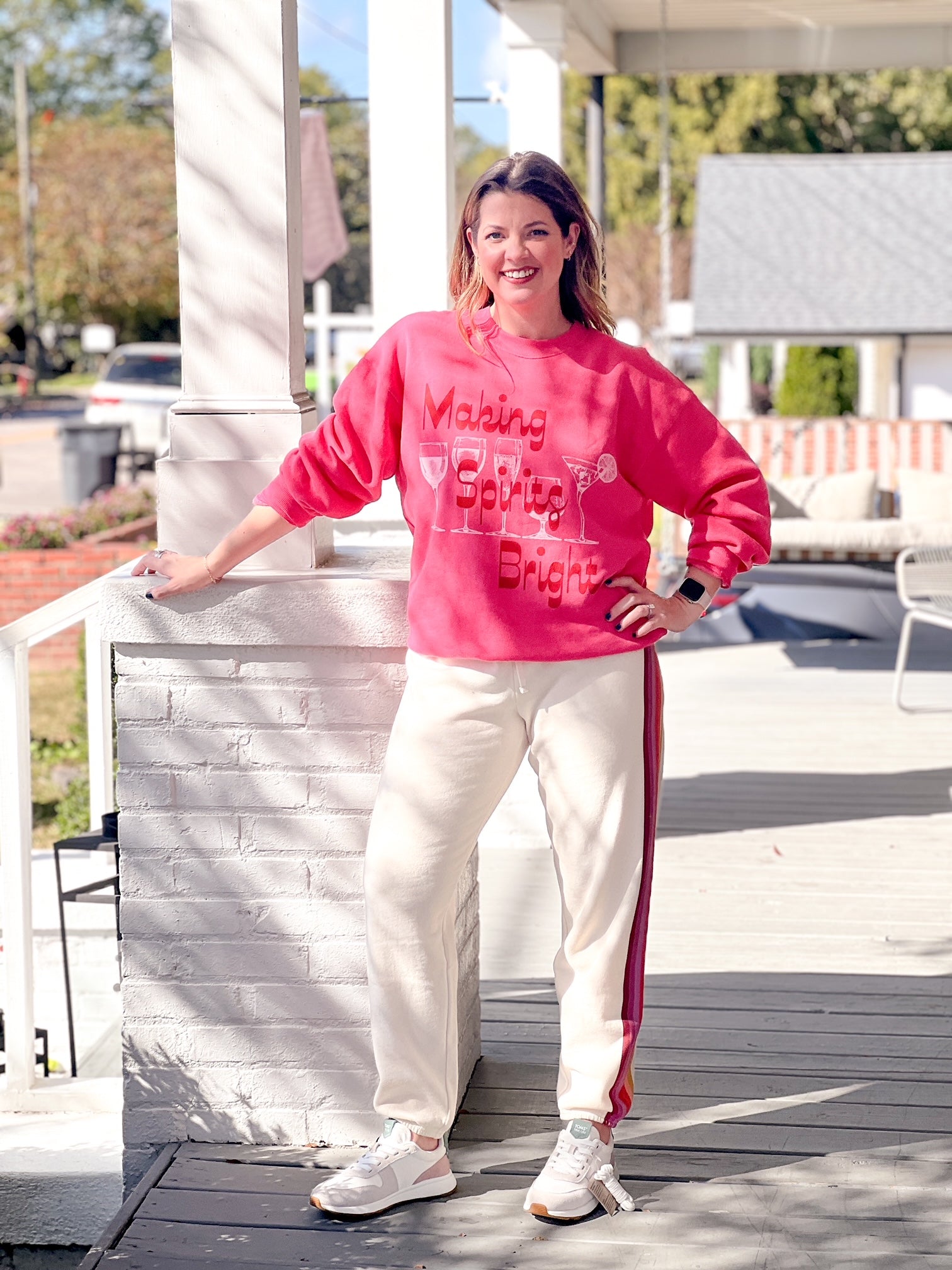 bright pink sweatshirt with "making spirits bright" written on the front. also includes spirited drinks on the front such as a martini.